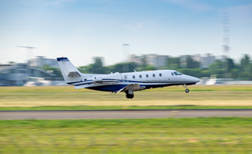 Small Aircraft landing on airport runway